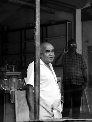 Shopkeeper standing in his shop